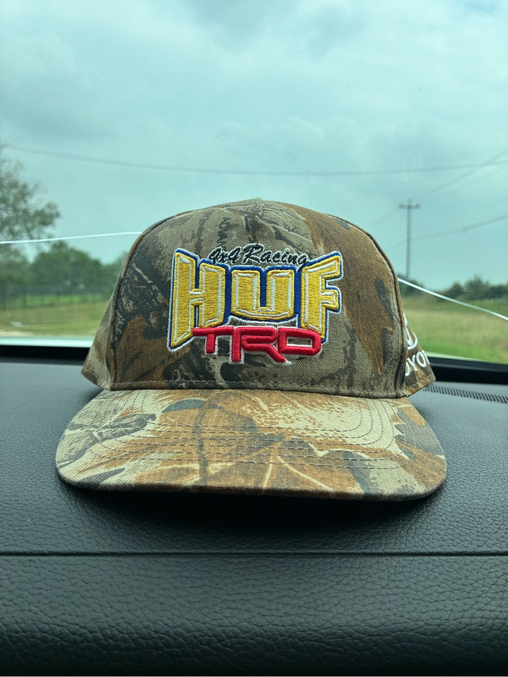 HUF Camouflage Cap with Yellow and Red Logo